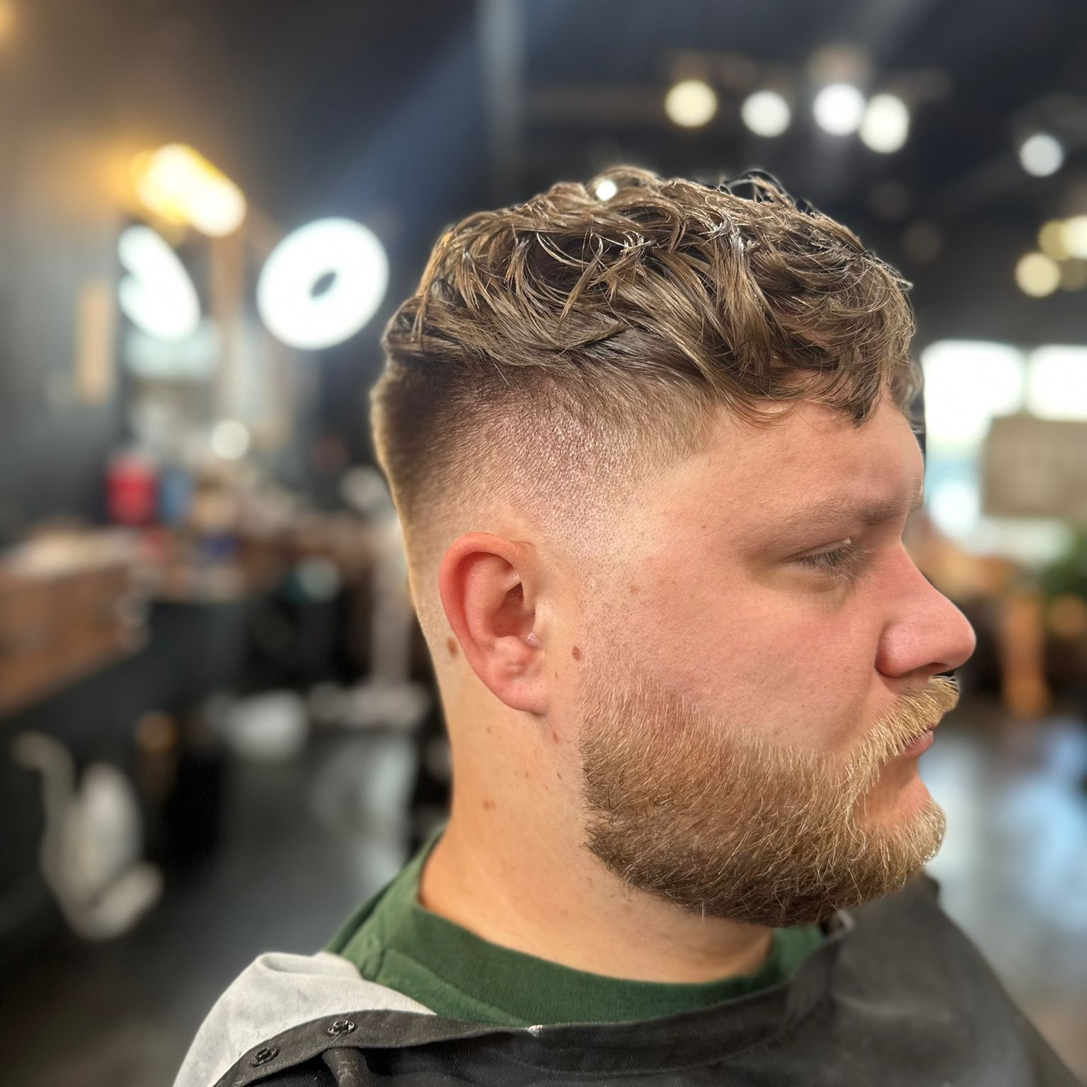 Curly crop with mid fade and full beard