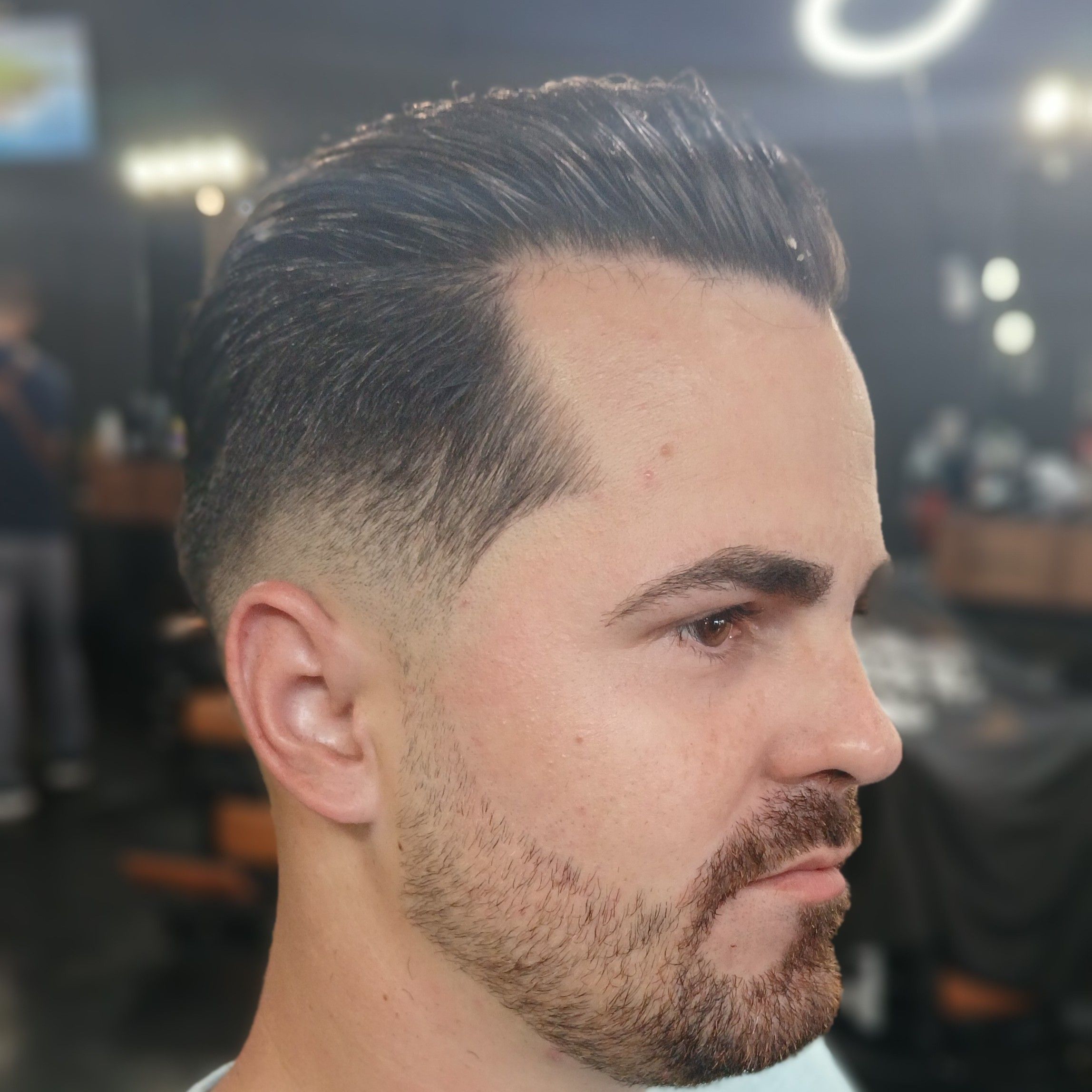 Slick back with low taper fade and beard sculpt